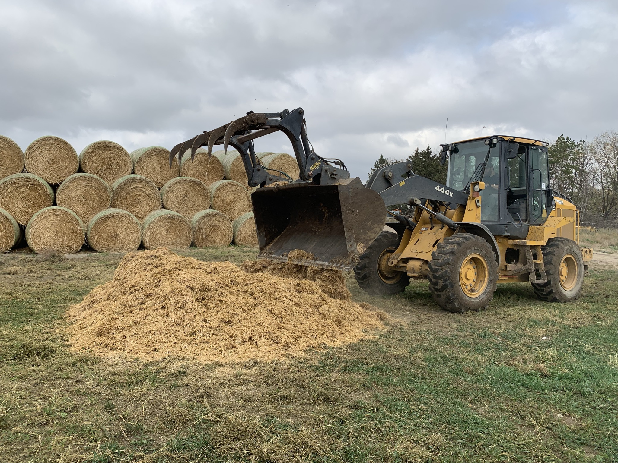 tractor placing hay for a base