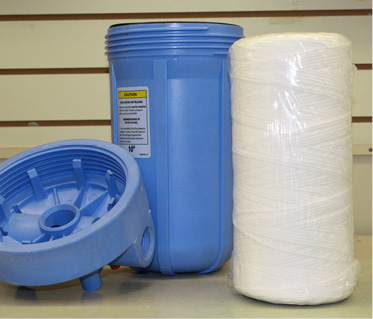 blue water filter casing with the smooth filter to the right of it 