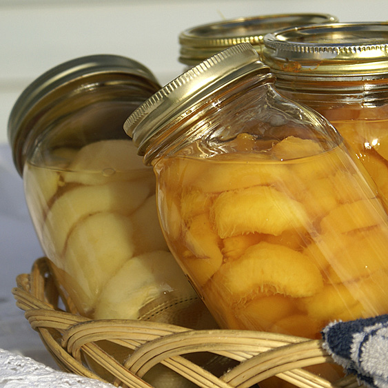 Jars of canned fruit in a basket