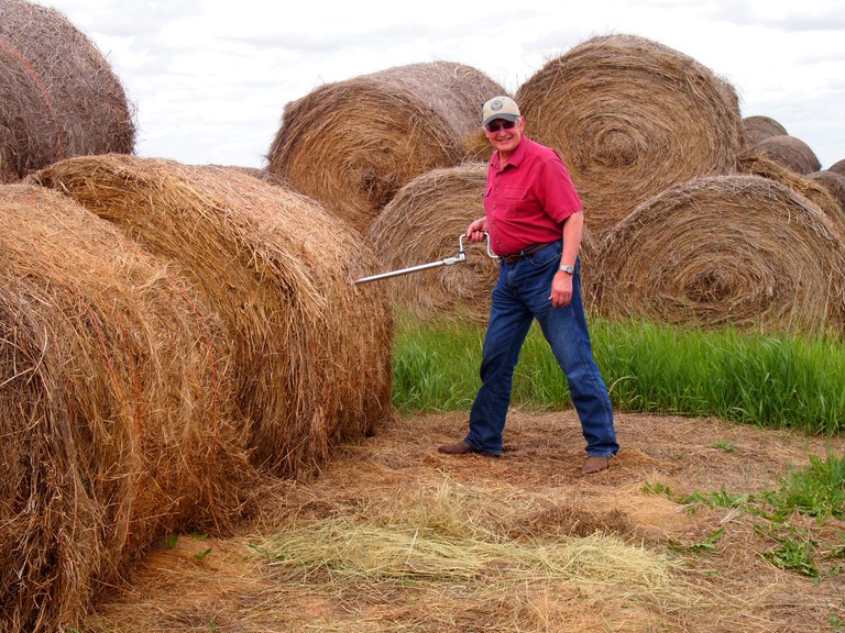 Figure 2. Forage sampling a round bale using a Penn State sampler with hand crank.
