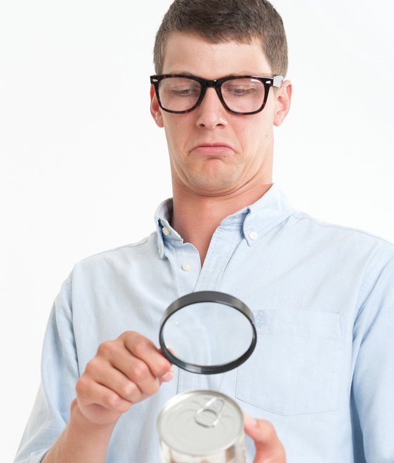 Man Reading Label On Can