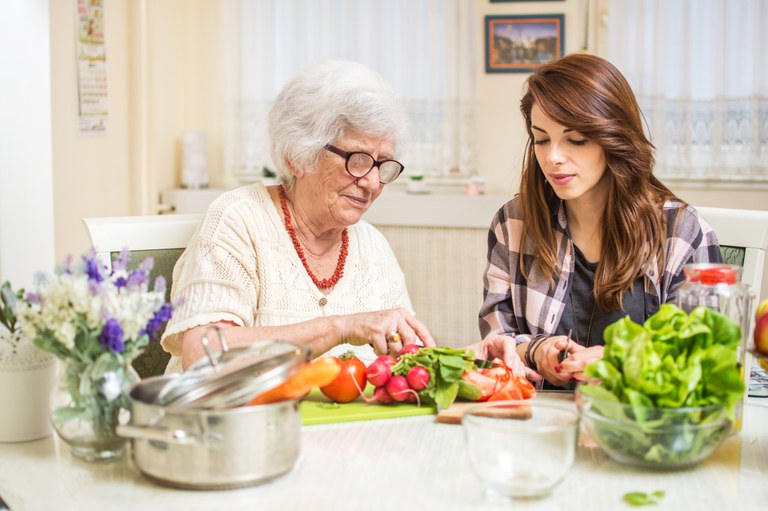 Two women preparing vegetables in the kitchen