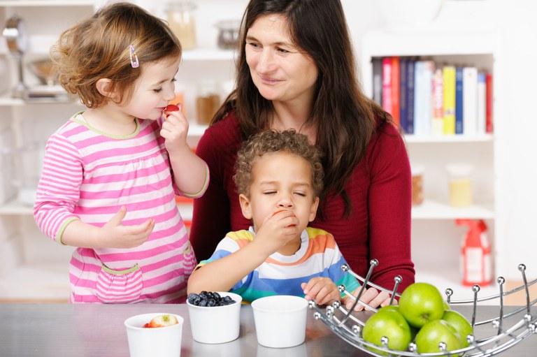Woman with preschoolers and snacks