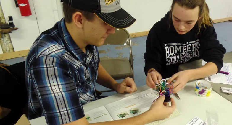 boy and girl building robot
