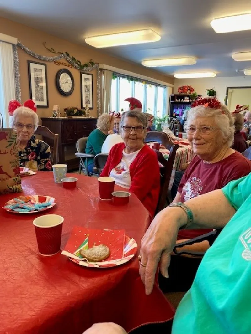elderly women enjoying treats at a table at a Christmas party