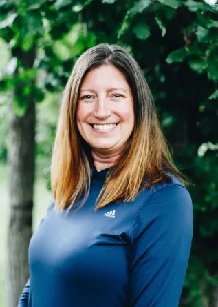 A woman with medium length brown hair smiles