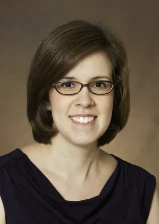 Laura Thomas smiling confidently at camera. 