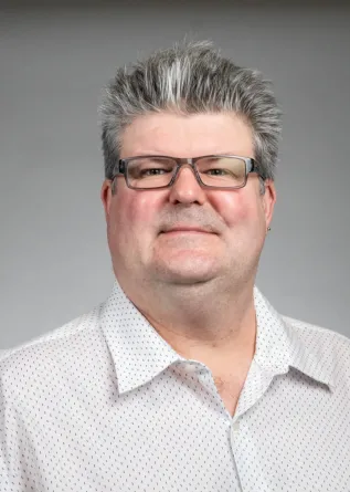 Chris Colbert looking confidently at camera.