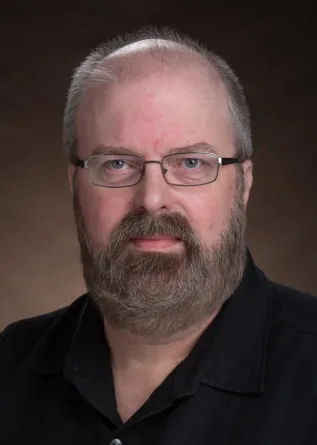 Seth Rasmussen smiling confidently at the camera