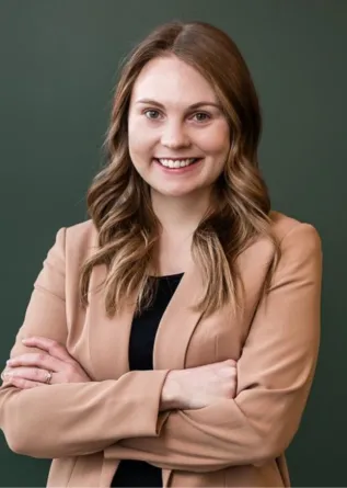 Alme smiling confidently at camera