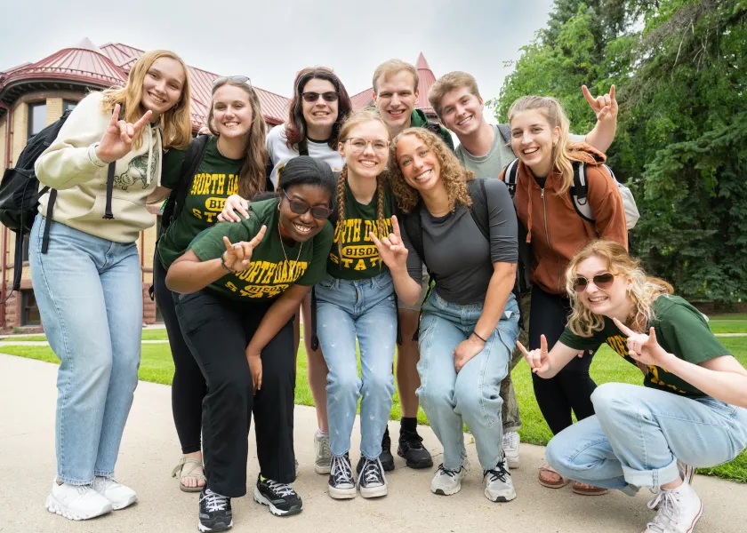 students posing on campus