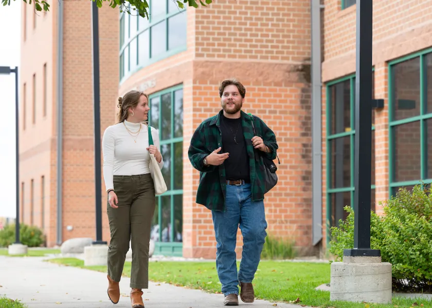 Two students walking and talking outside