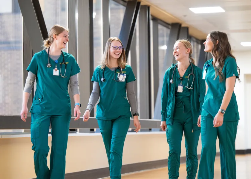 Four student nurses walking together at the School of Nursing at Sanford Health in Bismarck.