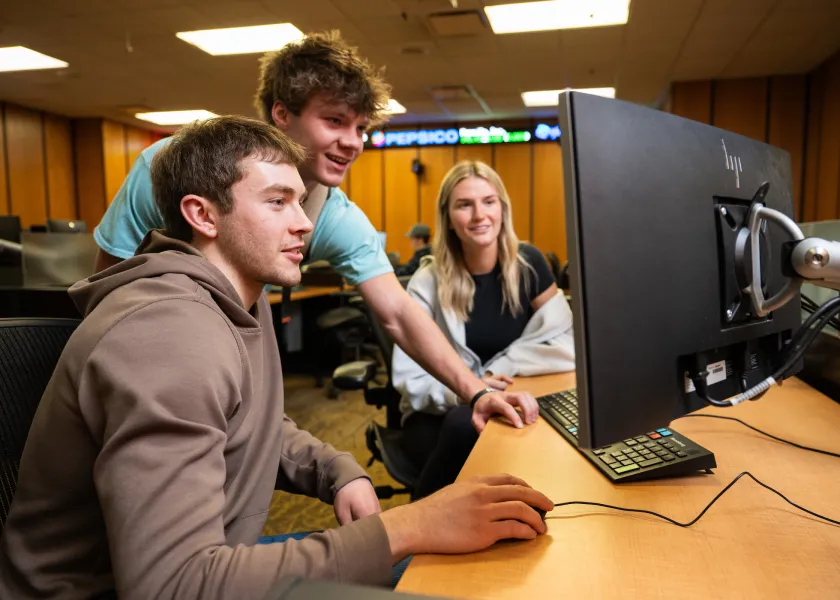 students looking at a computer monitor