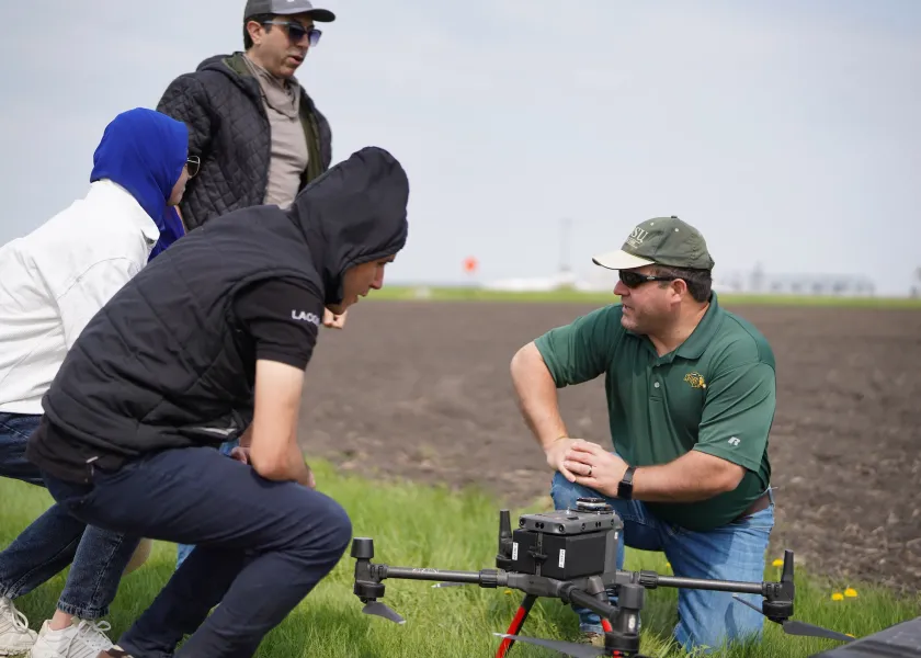Paulo Flores, North Dakota State University assistant professor of agricultural and biosystems engineering, with students in a field
