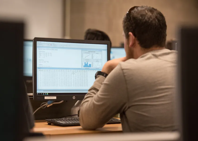 student viewing a statistics program on a monitor
