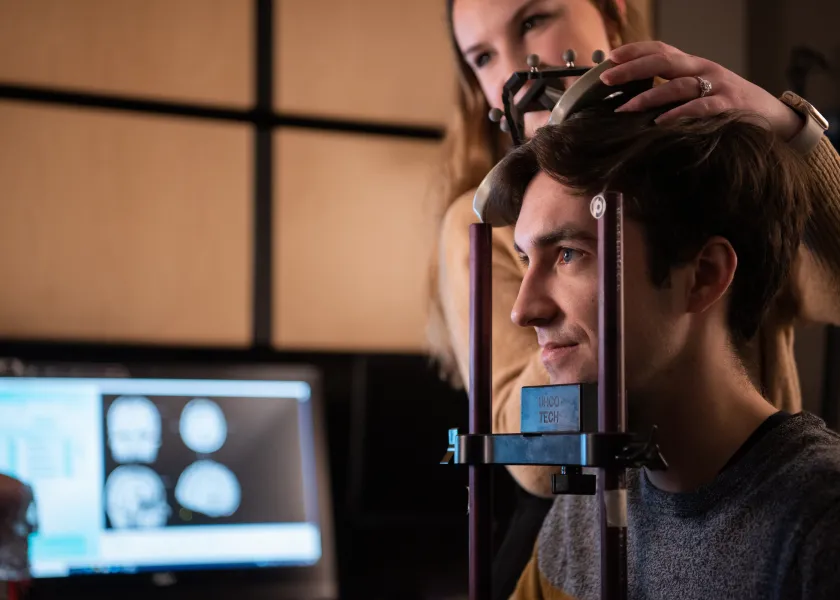 student taking measurements of a human head