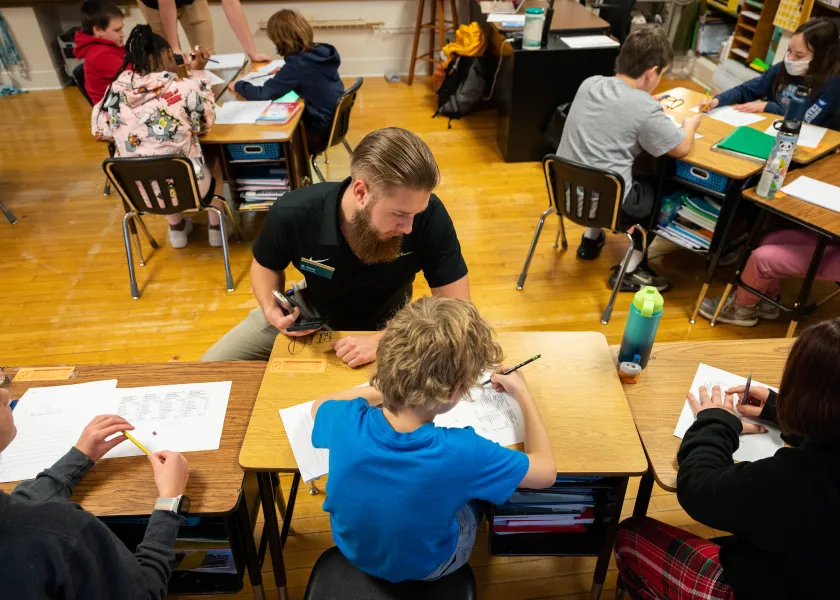 staff teaching children in a classroom