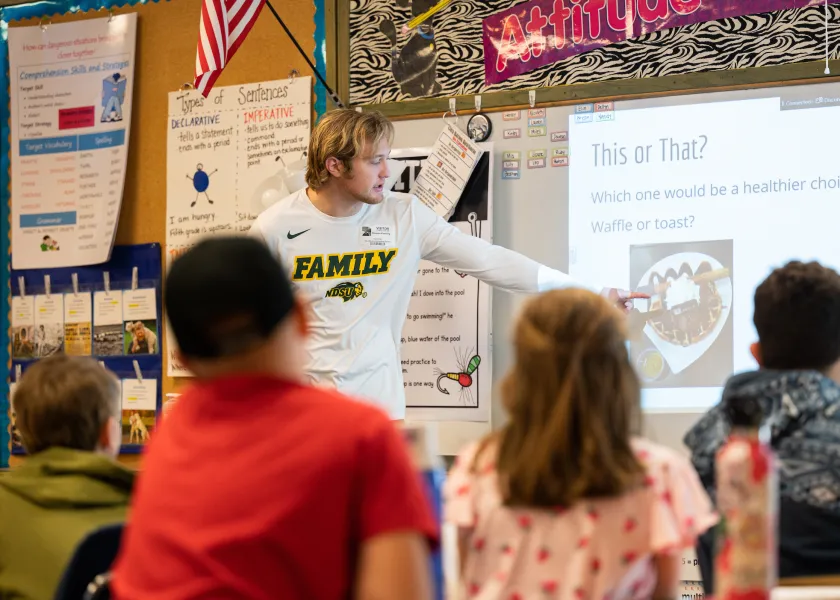 student making a presentation in front of a class