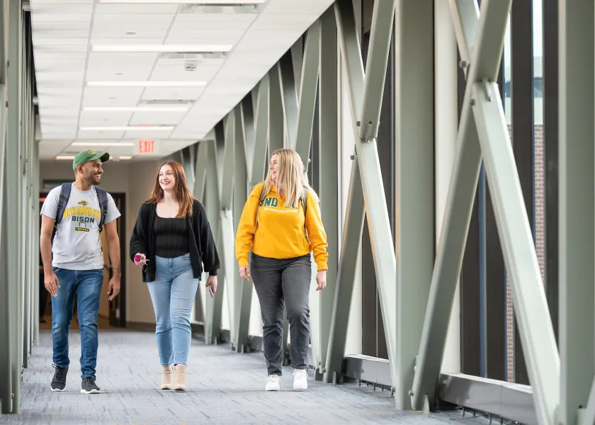 grad students walking through campus building