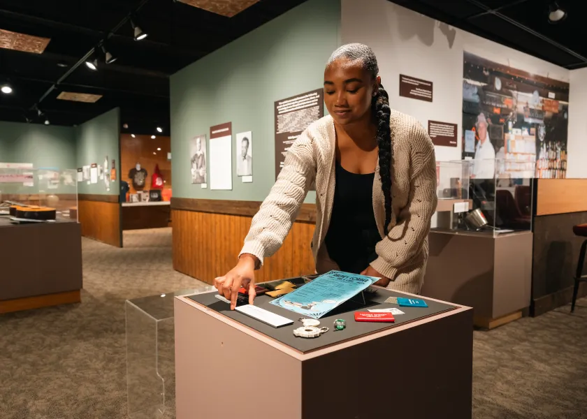 student positioning artifacts for an exhibit in a museum