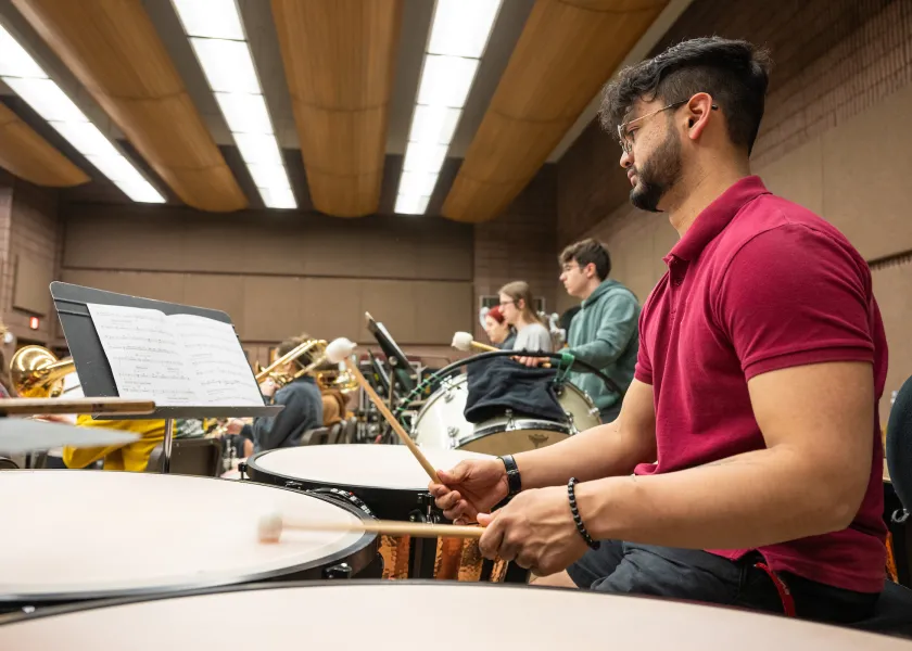 students in the percussion section practicing