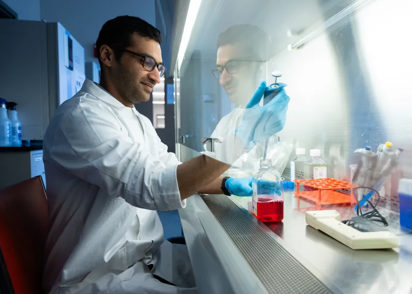 student working with a sample in a lab