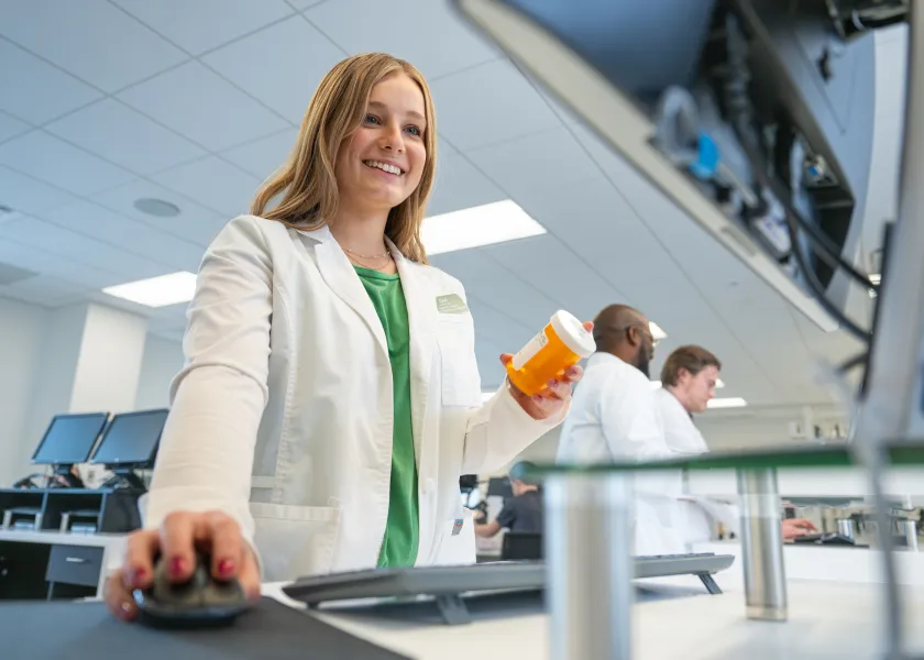 Pharmacy student filling a prescription