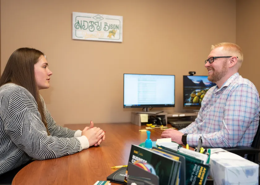 advisor Brad Jones talking with student Morgan Middleton