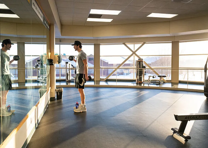 a student exercising at the Wallman Wellness Center