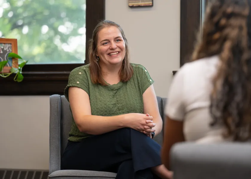 Shellie, Beeker, the director of 线上赌博app's Counseling Center sits in her office while listening to a student.