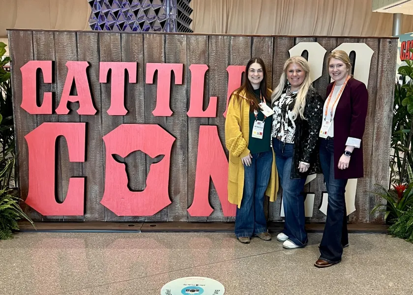 Photo of attendees in front of Cattlecon sign