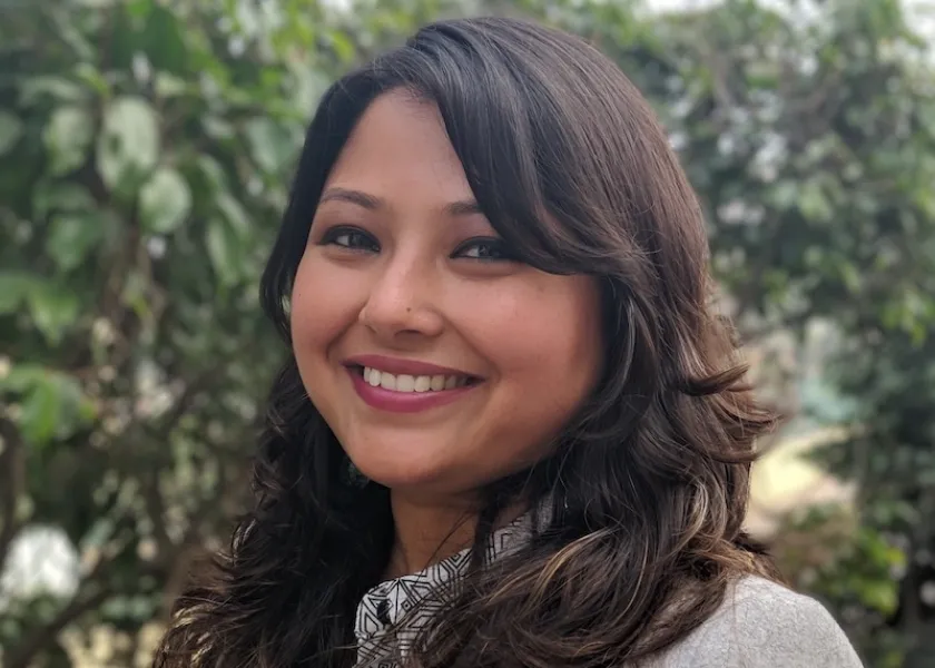 Pramita Sen poses in front of a tree.