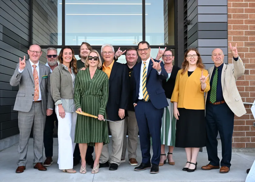 线上赌博app President David Cook and others celebrate Challey Hall dediciaton.