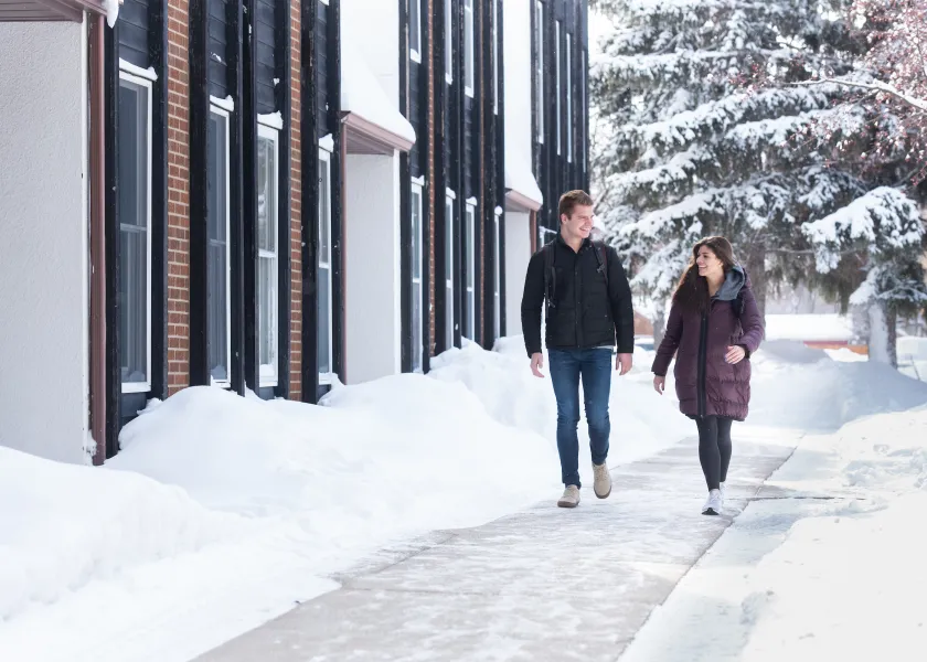 students walking near University Village in the winter