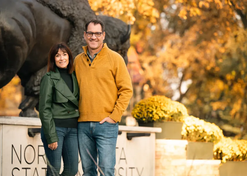 President and Kate Cook in front of the Bison statue