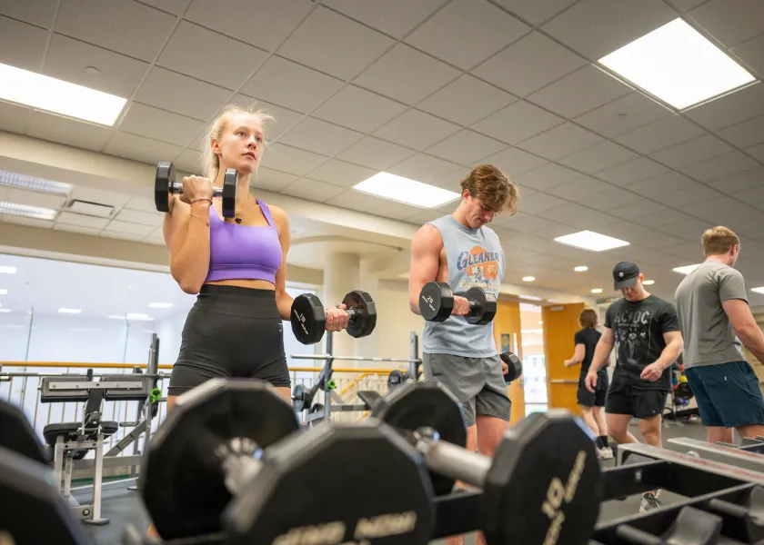 Student using free weights at the Wellness Center