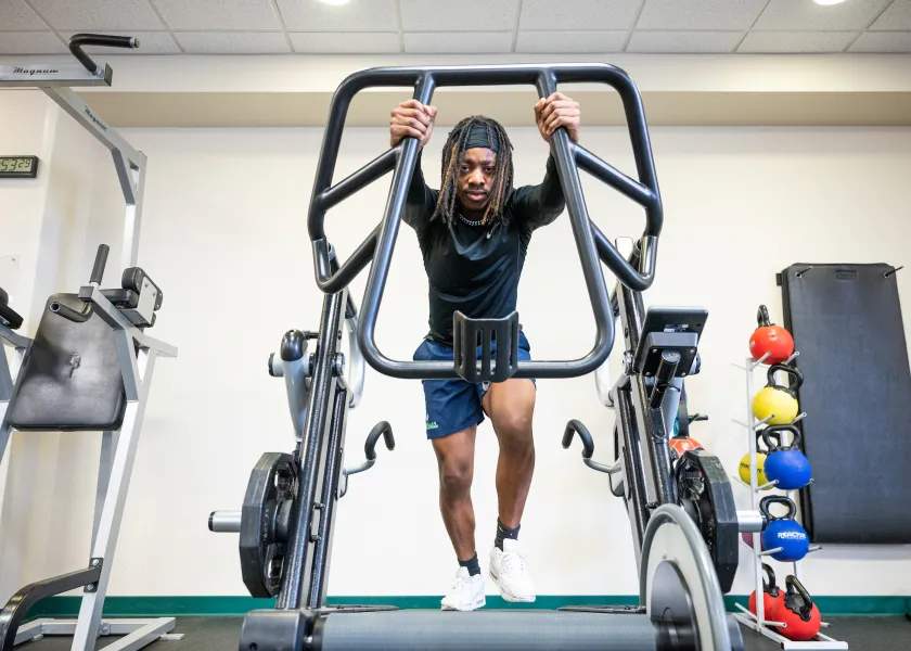 Student using workout equipment at the Wellness Center