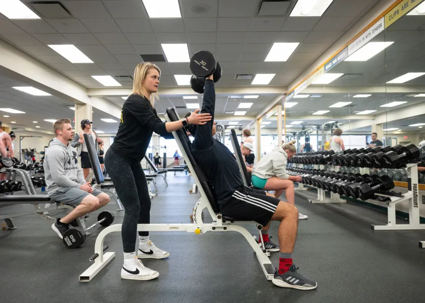 Student getting instructions from a personal trainer