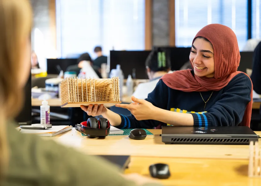 architecture students discussing their projects