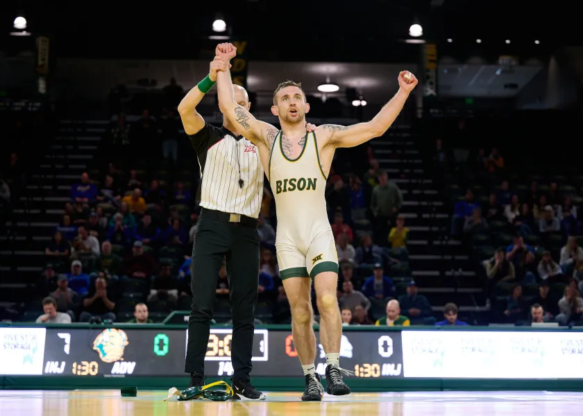 ndsu wrestler wins his match and celebrates with arms in the air
