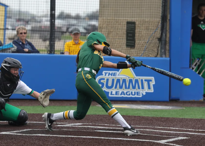 softball player batting during a game