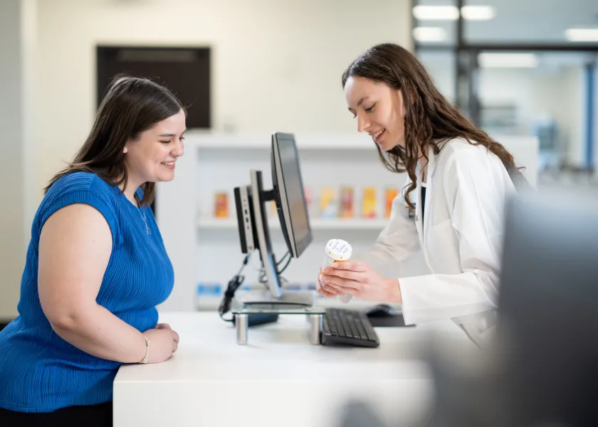 pharmacy students practice giving out prescriptions