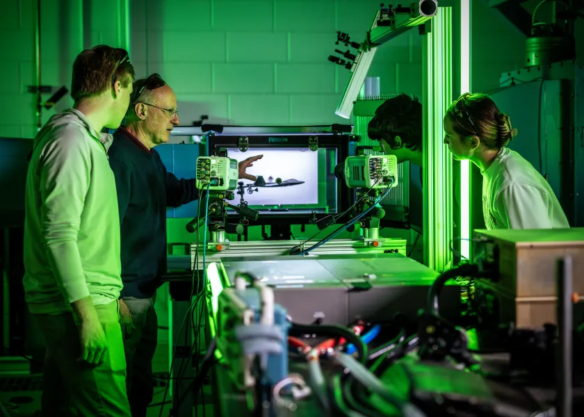 engineering students work with a wind tunnel during class