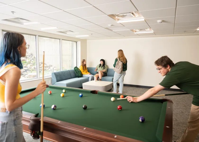 students playing pool in Pavek Hall 