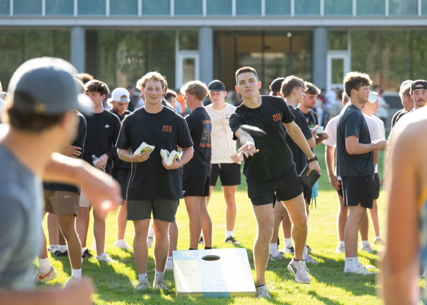 students playing corn hole during Greek Welcome Week