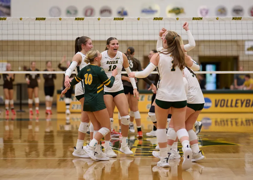 Bison volleyball team huddles before the game