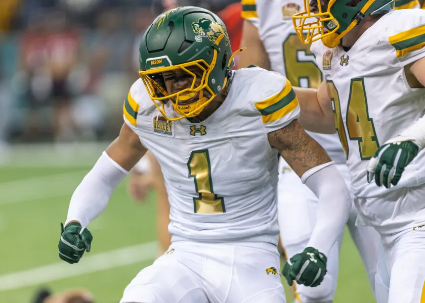 Bison football players celebrates after a successful play
