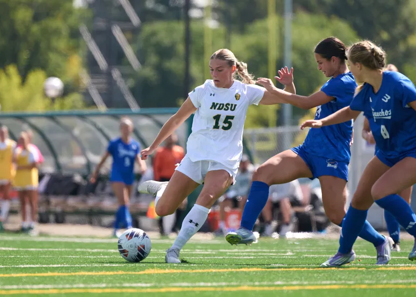 Bison soccer player bringing the ball down the field