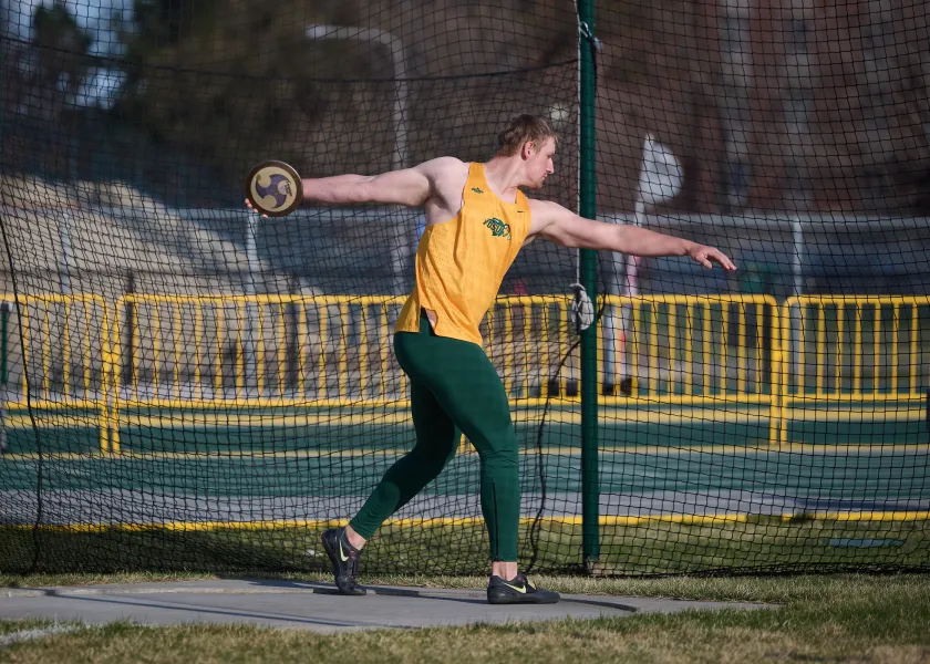 men's track athlete competing in discus